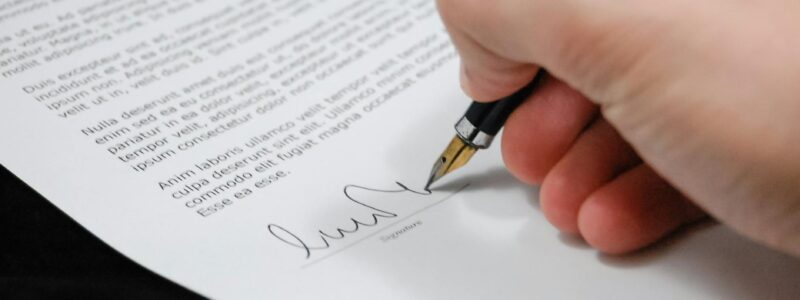 person signing in documentation paper